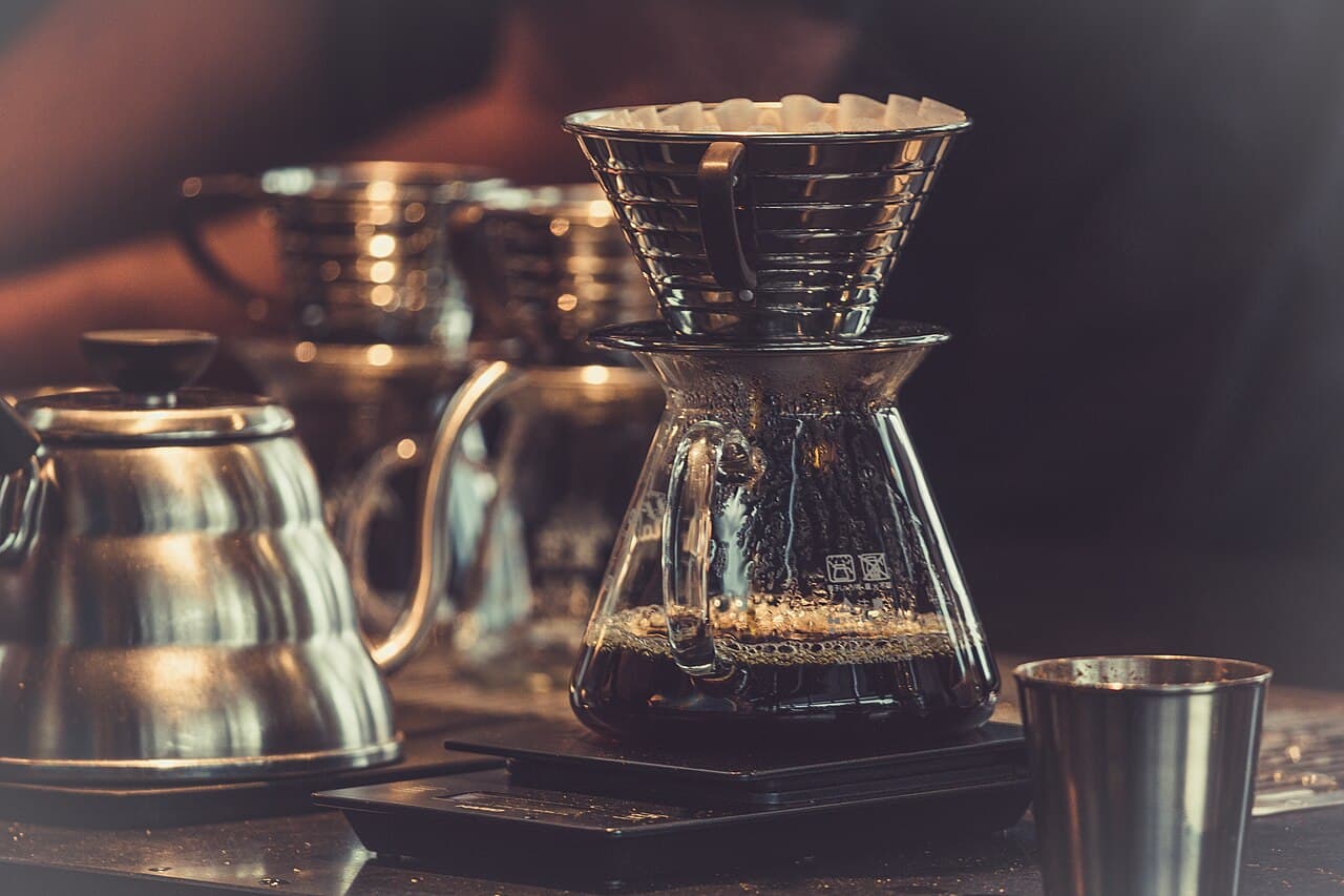Coffee dripping into a glass vessel on a counter